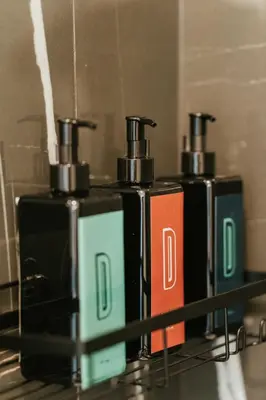 two bottles ofodorizers are sitting on a shelf at Welcoming and Light Filled 2bdr Apartment in Montréal