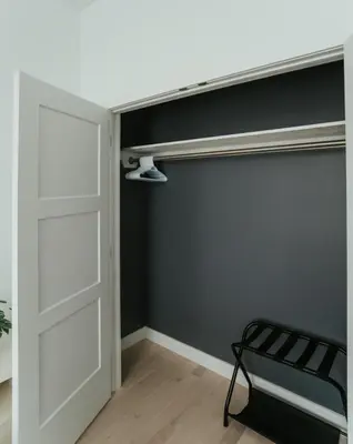a room with a white door and a black wall at Welcoming and Light Filled 2bdr Apartment in Montréal