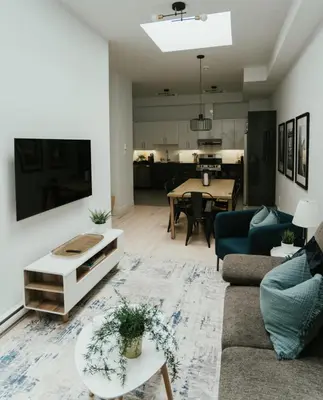 a living room with a couch and a table at Welcoming and Light Filled 2bdr Apartment in Montréal