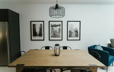a dining room with a table and a blue couch at Welcoming and Light Filled 2bdr Apartment in Montréal