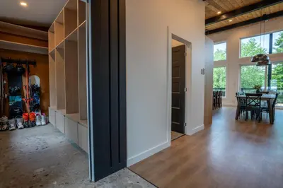 a hallway of a home with a dining room with a table at Évasion Nature Adstock - Sauna, Ski & Spa in Thetford Mines