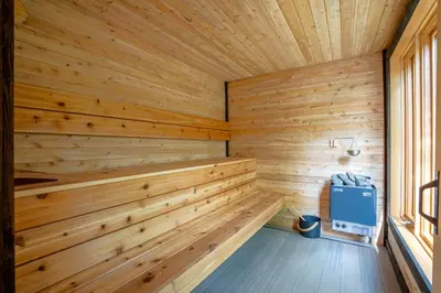 a sauna with wood paneling and a window at Évasion Nature Adstock - Sauna, Ski & Spa in Thetford Mines