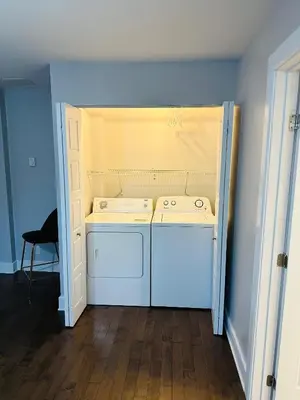 a kitchen with a white stove and a washer at Urban Retreat - 2 Bedroom, 3 Beds, 6 Guests, Free Parking in Longueuil