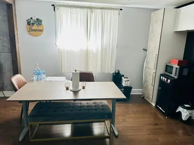a dining room table with a bench in front of a window at Urban Retreat - 2 Bedroom, 3 Beds, 6 Guests, Free Parking in Longueuil