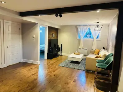 a living room with a couch and a table at Urban Retreat - 2 Bedroom, 3 Beds, 6 Guests, Free Parking in Longueuil