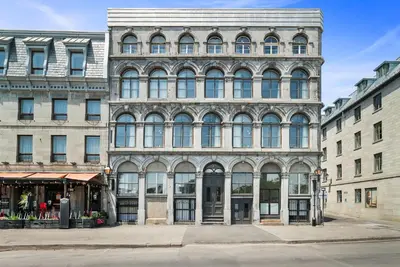 a large building with many windows on a city street at Arcadia Hotel Boutique in Montréal