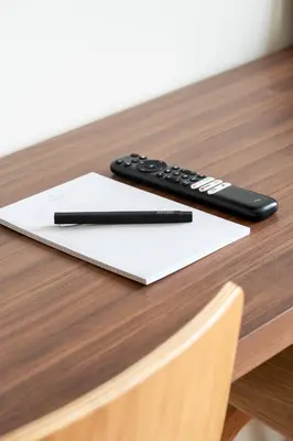 a remote control and a pen sitting on a table at Arcadia Hotel Boutique in Montréal