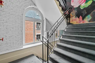 a staircase with a window and a brick wall at Arcadia Hotel Boutique in Montréal