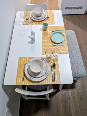 a white table with plates and dishes on it at Cozy Studio in Montreal's Quartier des Spectacles in Montréal