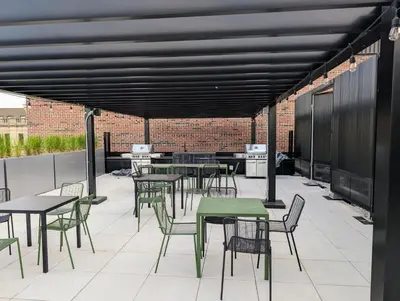 a patio with tables and chairs and a brick wall at Cozy Studio in Montreal's Quartier des Spectacles in Montréal