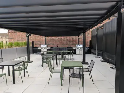 a group of tables and chairs on a patio at Cozy Studio in Montreal's Quartier des Spectacles in Montréal