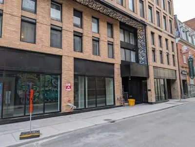 an empty street in front of a brick building at Cozy Studio in Montreal's Quartier des Spectacles in Montréal