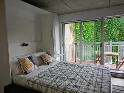 a bedroom with a bed and a large window at Cozy Studio in Montreal's Quartier des Spectacles in Montréal