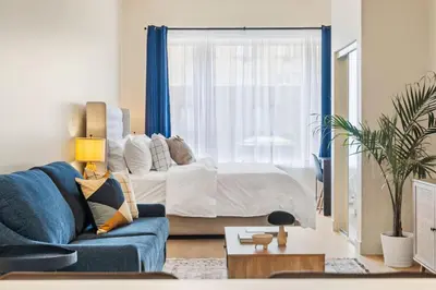 a living room with a bed and a blue couch at Central King Loft in Montréal