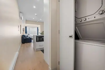 a hallway with a kitchen and a living room at Central King Loft in Montréal