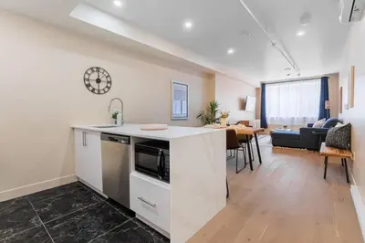 an open kitchen and living room in a apartment at Double King Luxury 2BR Condo in Montréal