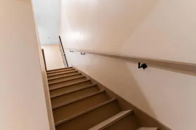 a staircase in a building with wooden steps at Double King Luxury 2BR Condo in Montréal