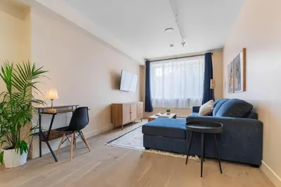 a living room with a blue couch and a table at Double King Luxury 2BR Condo in Montréal