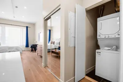 a kitchen with a refrigerator and a living room at Luxurious DownTown Suite in Montréal