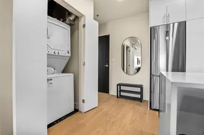 a white bathroom with a sink and a mirror at City Center King Suite in Montréal
