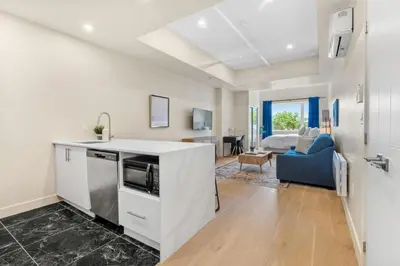 a kitchen with a counter and a living room at Luxe DownTown King Suite in Montréal