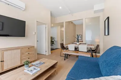 a living room with a couch and a table at Downtown 2BR Suite in Montréal