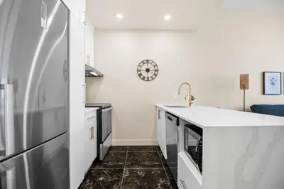 a kitchen with a refrigerator and a counter top at Central Studio in Montréal
