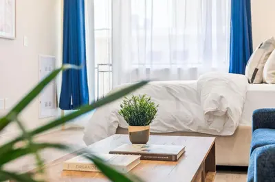 a living room with a coffee table with a potted plant at Central Suite with Balcony in Montréal
