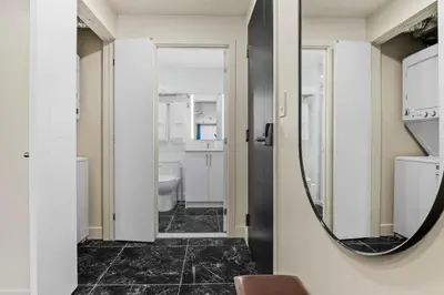 a bathroom with a mirror and a sink at Central Suite with Balcony in Montréal