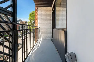 a balcony with a door and a view of a street at Luxurious King Suite with Balcony in Montréal