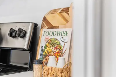 a basket with food waste next to a toaster oven at Luxurious King Suite with Balcony in Montréal