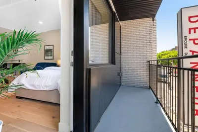 a view of a bedroom from a balcony with a bed at DownTown Studio with Balcony in Montréal
