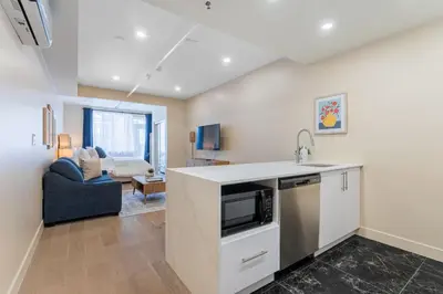 a kitchen with a sink and a microwave at DownTown King Suite with Balcony in Montréal