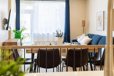 a living room with a table and chairs and a couch at 2BR Downtown Suite with Balcony in Montréal