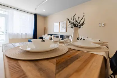 a table with plates and bowls on top of it at 2BR Downtown Suite with Balcony in Montréal