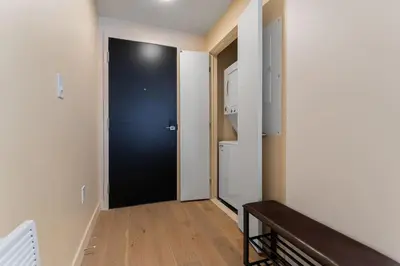 a hallway with a black door in a room at 2BR Downtown Suite with Balcony in Montréal