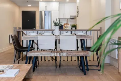 a dining room with a table and chairs in a kitchen at 2BR Downtown Suite with Balcony in Montréal