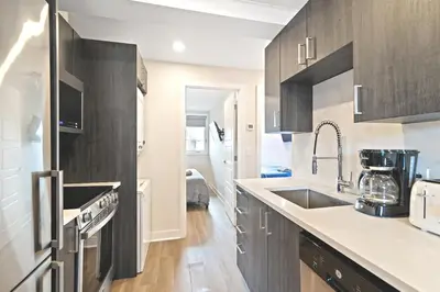 a kitchen with a sink and a counter top at Cozy 3BDR in heart of plateau Montreal D in Montréal