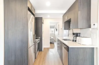 a kitchen with gray cabinets and a white counter top at Cozy 3BDR in heart of plateau Montreal D in Montréal