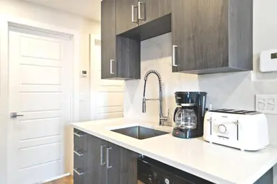 a kitchen with a sink and a counter top at Cozy 3BDR in heart of plateau Montreal D in Montréal