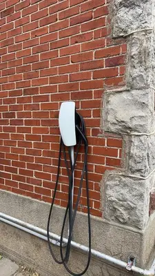 a white phone on the side of a brick wall at Walk on the riverside in Montréal