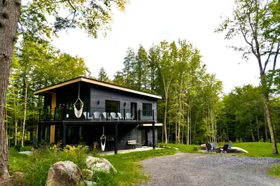 a house in the middle of a forest at Pur Nature et Spa Owl's Head in Mansonville