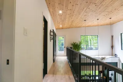 a hallway of a home with a wooden ceiling at Pur Nature et Spa Owl's Head in Mansonville