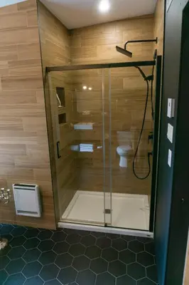 a bathroom with a shower and a toilet in it at Pur Nature et Spa Owl's Head in Mansonville