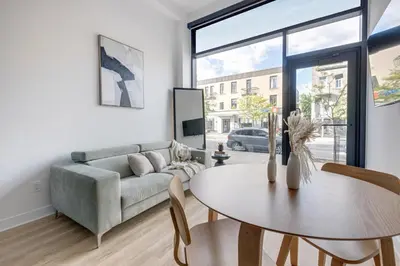a living room with a couch and a table at Le Mile End by M11 - Luxurious & Cozy 1BDR Unit in Montréal