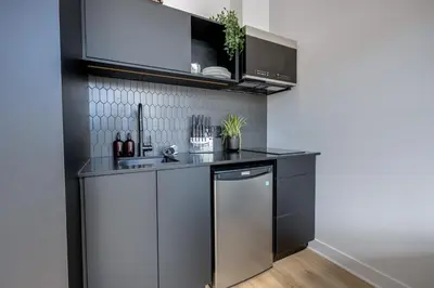 a kitchen with a sink and a dishwasher at Le Mile End by M11 - Luxurious & Cozy 1BDR Unit in Montréal