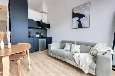 a living room with a couch and a table at Le Mile End by M11 - Luxurious & Cozy 1BDR Unit in Montréal