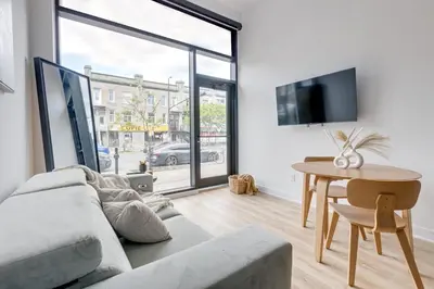a living room with a couch and a table at Le Mile End by M11 - Luxurious & Cozy 1BDR Unit in Montréal