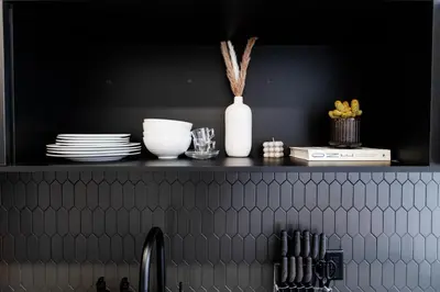 a kitchen shelf with plates and dishes on it at Le Mile End by M11 - Luxurious & Cozy 1BDR Unit in Montréal