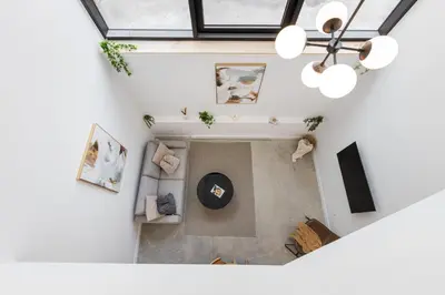 an overhead view of a living room with a chandelier at Le Mile End by M11 - 2 BDR Loft with Sofa Bed in Montréal